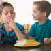 two-boys-eating-snack-of-celery-carrots